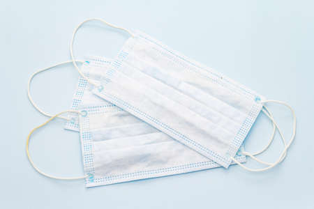 Masks isolated on blue background. Medical products for personal hygiene and the prevention of viral...