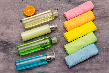 Set of colorful dusters and house cleaning product, home disinfection in quarantine. Gray stone concrete background, top view, copy spaceの写真素材