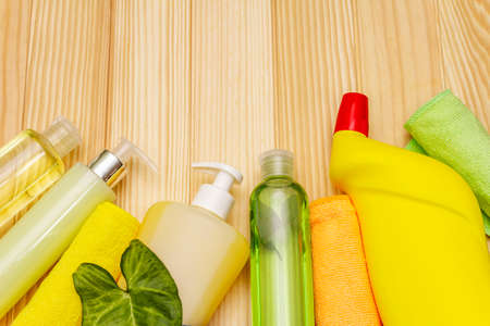 House cleaning product. Spray, bottle, soap, dishwashing sponge, duster, gel air freshener. Home disinfection in quarantine. Wooden boards backgroundの写真素材