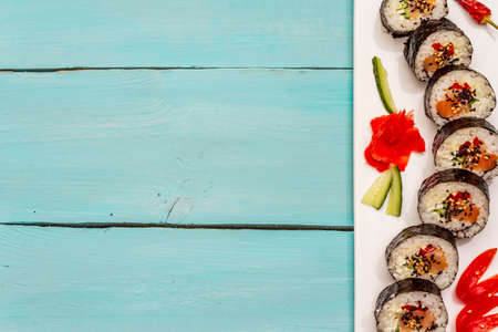 Korean roll Gimbap(kimbob). Steamed white rice (bap) and various other ingredients. Trendy turquoise wooden boards backgroundの写真素材