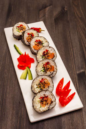 Korean roll Gimbap(kimbob). Steamed white rice (bap) and various other ingredients. Trendy black wooden boards backgroundの写真素材