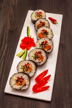 Korean roll Gimbap(kimbob). Steamed white rice (bap) and various other ingredients. Trendy black wooden boards backgroundの写真素材
