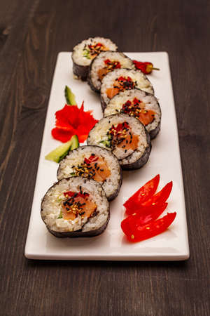 Korean roll Gimbap(kimbob). Steamed white rice (bap) and various other ingredients. Trendy black wooden boards backgroundの写真素材