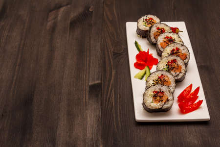 Korean roll Gimbap(kimbob). Steamed white rice (bap) and various other ingredients. Trendy black wooden boards backgroundの写真素材