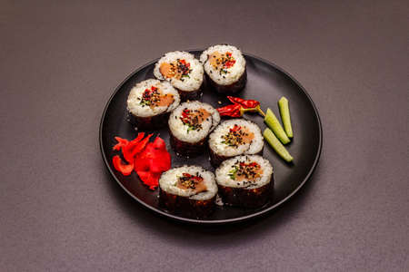 Korean roll Gimbap(kimbob). Steamed white rice (bap) and various other ingredients. Trendy black stone concrete backgroundの写真素材