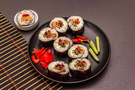 Korean roll Gimbap(kimbob). Steamed white rice (bap) and various other ingredients. Trendy black stone concrete backgroundの写真素材