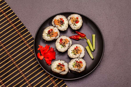Korean roll Gimbap(kimbob). Steamed white rice (bap) and various other ingredients. Trendy black stone concrete backgroundの写真素材