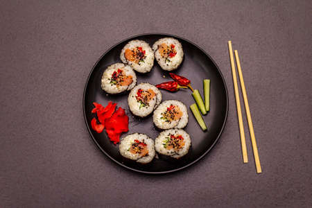 Korean roll Gimbap(kimbob). Steamed white rice (bap) and various other ingredients. Trendy black stone concrete backgroundの写真素材