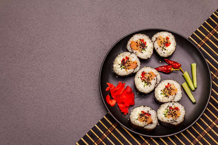 Korean roll Gimbap(kimbob). Steamed white rice (bap) and various other ingredients. Trendy black stone concrete backgroundの写真素材