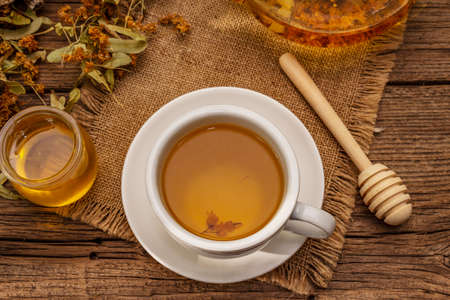 Linden tea. Dry fragrant flowers. Sunny morning breakfast. Hot drink to strengthen the immune system, alternative medicine. Vintage wooden tableの写真素材