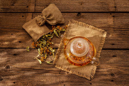 Linden tea. Dry fragrant flowers. Sunny morning breakfast. Hot drink to strengthen the immune system, alternative medicine. Vintage wooden tableの写真素材