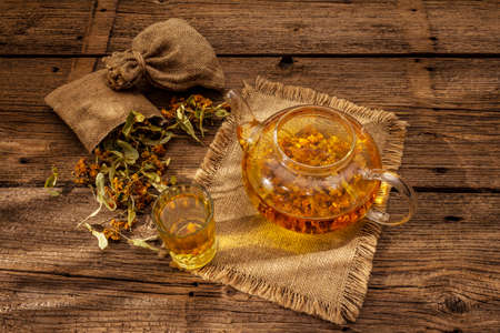 Linden tea. Dry fragrant flowers. Sunny morning breakfast. Hot drink to strengthen the immune system, alternative medicine. Vintage wooden tableの写真素材