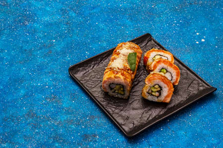 Grilled tiger prawn sushi. Japanese or Korean roll with different fresh ingredients. Nautical blue backgroundの写真素材