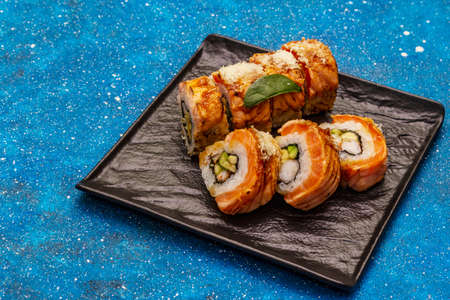 Grilled tiger prawn sushi. Japanese or Korean roll with different fresh ingredients. Nautical blue backgroundの写真素材