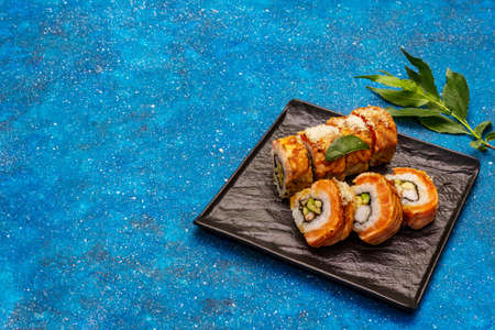 Grilled tiger prawn sushi. Japanese or Korean roll with different fresh ingredients. Nautical blue backgroundの写真素材