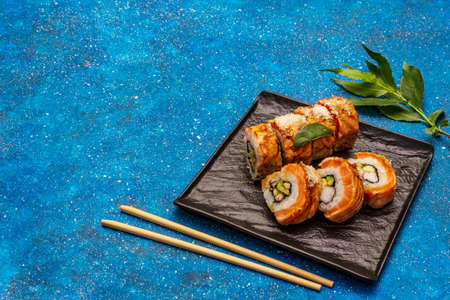 Grilled tiger prawn sushi. Japanese or Korean roll with different fresh ingredients. Nautical blue backgroundの写真素材