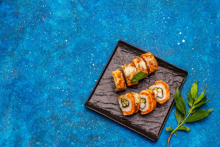 Grilled tiger prawn sushi. Japanese or Korean roll with different fresh ingredients. Nautical blue backgroundの写真素材