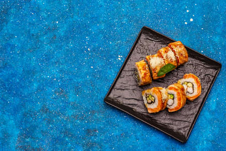 Grilled tiger prawn sushi. Japanese or Korean roll with different fresh ingredients. Nautical blue backgroundの写真素材