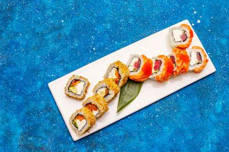 Assorted sushi set. Japanese or Korean roll with different fresh ingredients. Nautical blue backgroundの写真素材