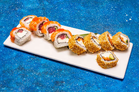 Assorted sushi set. Japanese or Korean roll with different fresh ingredients. Nautical blue backgroundの写真素材