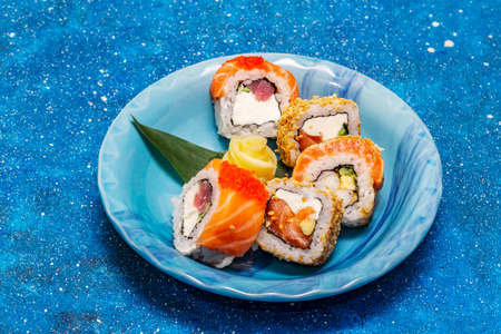 Assorted sushi set. Japanese or Korean roll with different fresh ingredients. Nautical blue backgroundの写真素材