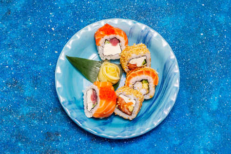 Assorted sushi set. Japanese or Korean roll with different fresh ingredients. Nautical blue backgroundの写真素材