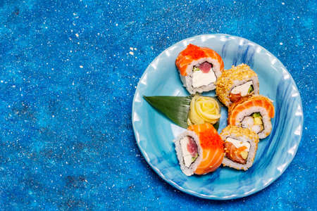 Assorted sushi set. Japanese or Korean roll with different fresh ingredients. Nautical blue backgroundの写真素材