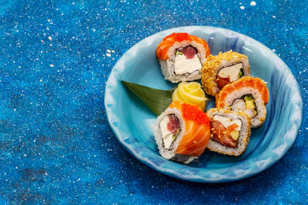 Assorted sushi set. Japanese or Korean roll with different fresh ingredients. Nautical blue backgroundの写真素材