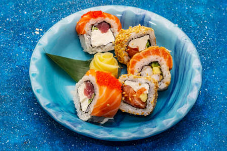 Assorted sushi set. Japanese or Korean roll with different fresh ingredients. Nautical blue backgroundの写真素材