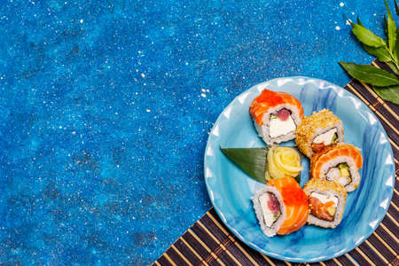 Assorted sushi set. Japanese or Korean roll with different fresh ingredients. Nautical blue backgroundの写真素材