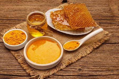 Spa concept. Self care with honey and turmeric. Natural organic cosmetics, homemade product, alternative lifestyle. Vintage wooden backgroundの写真素材