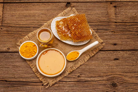 Spa concept. Self care with honey and turmeric. Natural organic cosmetics, homemade product, alternative lifestyle. Vintage wooden backgroundの写真素材