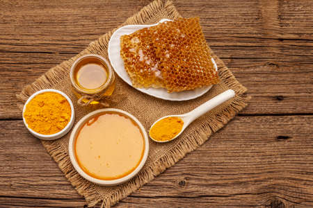 Spa concept. Self care with honey and turmeric. Natural organic cosmetics, homemade product, alternative lifestyle. Vintage wooden backgroundの写真素材