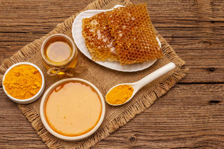 Spa concept. Self care with honey and turmeric. Natural organic cosmetics, homemade product, alternative lifestyle. Vintage wooden backgroundの写真素材