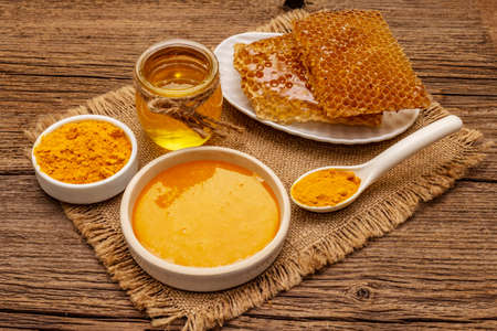 Spa concept. Self care with honey and turmeric. Natural organic cosmetics, homemade product, alternative lifestyle. Vintage wooden backgroundの写真素材