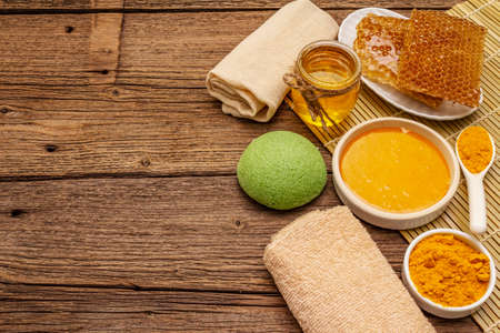 Spa concept. Self care with honey and turmeric. Natural organic cosmetics, homemade product, alternative lifestyle. Vintage wooden backgroundの写真素材