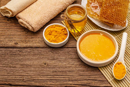 Spa concept. Self care with honey and turmeric. Natural organic cosmetics, homemade product, alternative lifestyle. Vintage wooden backgroundの写真素材