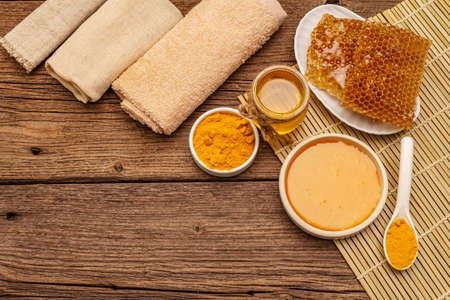 Spa concept. Self care with honey and turmeric. Natural organic cosmetics, homemade product, alternative lifestyle. Vintage wooden backgroundの写真素材