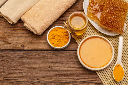 Spa concept. Self care with honey and turmeric. Natural organic cosmetics, homemade product, alternative lifestyle. Vintage wooden backgroundの写真素材