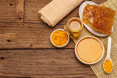 Spa concept. Self care with honey and turmeric. Natural organic cosmetics, homemade product, alternative lifestyle. Vintage wooden backgroundの写真素材