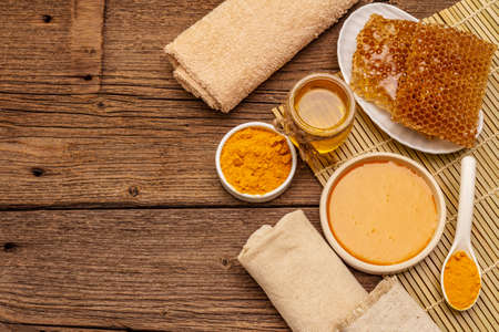 Spa concept. Self care with honey and turmeric. Natural organic cosmetics, homemade product, alternative lifestyle. Vintage wooden backgroundの写真素材