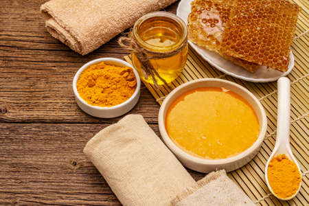 Spa concept. Self care with honey and turmeric. Natural organic cosmetics, homemade product, alternative lifestyle. Vintage wooden backgroundの写真素材