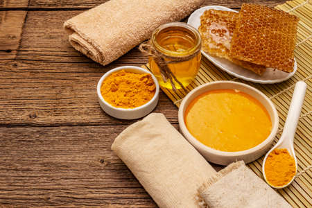 Spa concept. Self care with honey and turmeric. Natural organic cosmetics, homemade product, alternative lifestyle. Vintage wooden backgroundの写真素材