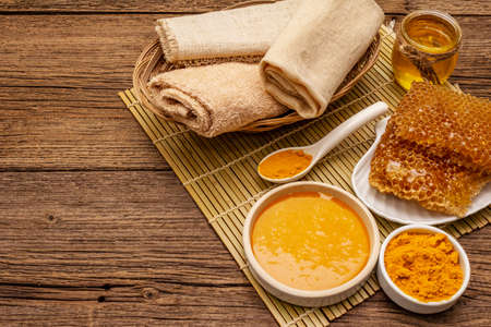 Spa concept. Self care with honey and turmeric. Natural organic cosmetics, homemade product, alternative lifestyle. Vintage wooden backgroundの写真素材