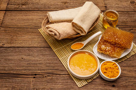 Spa concept. Self care with honey and turmeric. Natural organic cosmetics, homemade product, alternative lifestyle. Vintage wooden backgroundの写真素材