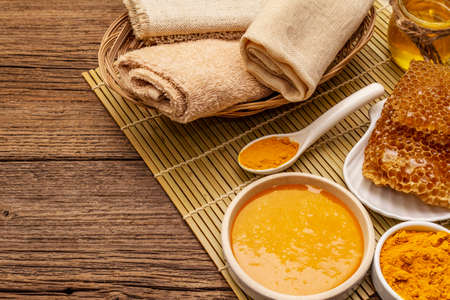 Spa concept. Self care with honey and turmeric. Natural organic cosmetics, homemade product, alternative lifestyle. Vintage wooden backgroundの写真素材