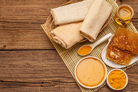 Spa concept. Self care with honey and turmeric. Natural organic cosmetics, homemade product, alternative lifestyle. Vintage wooden backgroundの写真素材