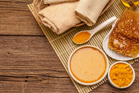 Spa concept. Self care with honey and turmeric. Natural organic cosmetics, homemade product, alternative lifestyle. Vintage wooden backgroundの写真素材
