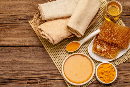 Spa concept. Self care with honey and turmeric. Natural organic cosmetics, homemade product, alternative lifestyle. Vintage wooden backgroundの写真素材