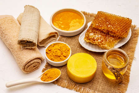 Spa concept. Self care with honey and turmeric. Natural organic cosmetics, homemade product, alternative lifestyle. White putty backgroundの写真素材